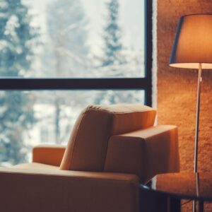 chair by a window with snowy landscape outside 
